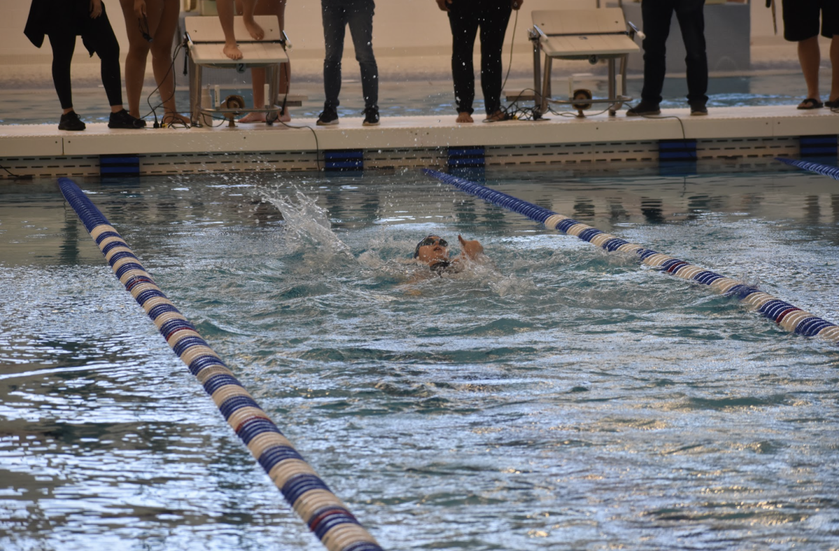 Lucinda Delaney (10) does back stroke through the water in the first race of the day in lane 2 to try to get the lead for her team. 